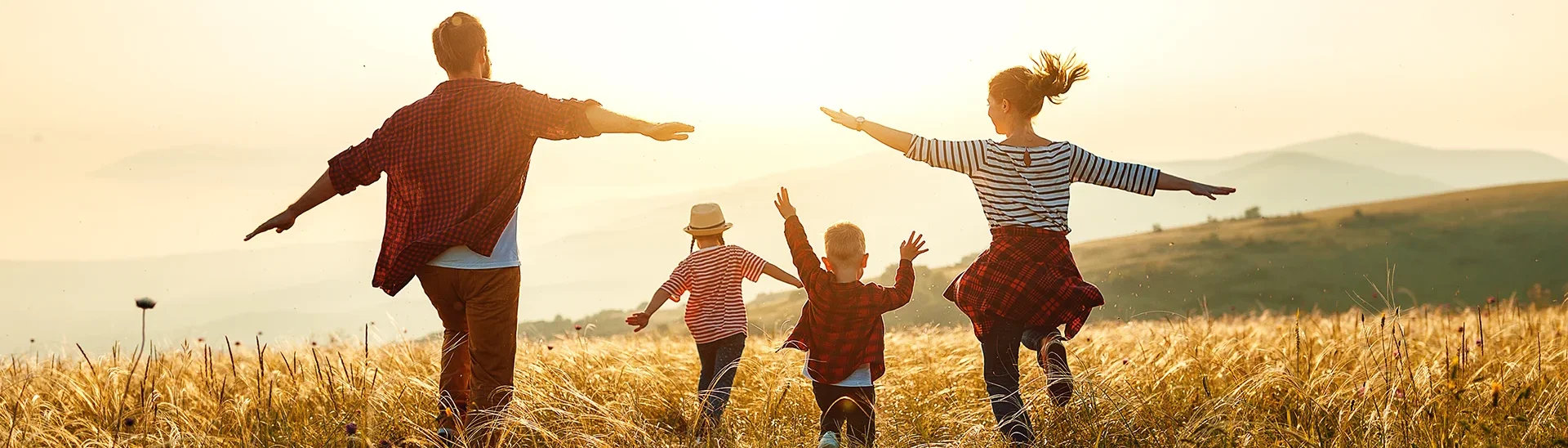 Happy family running in a field